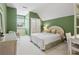 Charming bedroom with green walls, white wicker furniture, and natural light at 320 Morganshire Pl, Atlanta, GA 30350