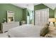 Bedroom featuring green walls, white wicker furniture, and carpet at 320 Morganshire Pl, Atlanta, GA 30350