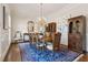 Elegant dining room with hardwood floors, chandelier, and ample seating for dinner guests at 320 Morganshire Pl, Atlanta, GA 30350