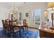 Bright dining room featuring large windows, hardwood floors, and classic furnishings at 320 Morganshire Pl, Atlanta, GA 30350