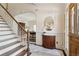 Inviting foyer with staircase, marble floors, and view into a room with a wooden desk at 320 Morganshire Pl, Atlanta, GA 30350