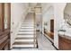 Elegant foyer with marble flooring, staircase, and arched doorway leading to other rooms at 320 Morganshire Pl, Atlanta, GA 30350