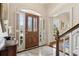 Bright foyer featuring marble floors, detailed trim, and a wooden front door with sidelights at 320 Morganshire Pl, Atlanta, GA 30350