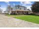 Charming home with manicured lawn, brick pathway, and welcoming front porch at 320 Morganshire Pl, Atlanta, GA 30350