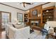 Relaxing living room with a brick fireplace, custom built-ins, and comfortable seating at 320 Morganshire Pl, Atlanta, GA 30350