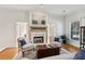 Bright living room with fireplace, stylish furniture, and plenty of natural light at 320 Morganshire Pl, Atlanta, GA 30350