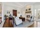 Bright living room with fireplace, hardwood floors, and classic furniture arrangement at 320 Morganshire Pl, Atlanta, GA 30350