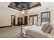 This spacious main bedroom offers a tray ceiling with decorative painting, carpet floors, and natural light at 320 Morganshire Pl, Atlanta, GA 30350