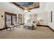 This spacious main bedroom offers a tray ceiling with decorative painting, carpet floors, and natural light at 320 Morganshire Pl, Atlanta, GA 30350