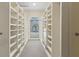 This large walk-in closet features custom built-in shelving and drawers for organization at 320 Morganshire Pl, Atlanta, GA 30350