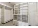 This walk-in closet features custom built-in shelving, wire baskets, and drawers for organization at 320 Morganshire Pl, Atlanta, GA 30350