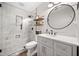 Bright bathroom featuring white marble, a glass shower, and a grey vanity at 327 Horseshoe Bend Bnd, Woodstock, GA 30189