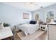 Bedroom with hardwood floors, a fan, a large window, and blue walls at 327 Horseshoe Bnd, Woodstock, GA 30189