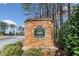 Stone entrance sign for Deer Run North neighborhood with mature landscaping and a tranquil setting at 327 Horseshoe Bnd, Woodstock, GA 30189