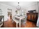 Cozy dining room with a wooden table, a chandelier, and ample room for hosting guests at 327 Horseshoe Bend Bnd, Woodstock, GA 30189