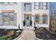 Home entrance with stone walkway, featuring updated windows and trim, and professionally landscaped garden at 327 Horseshoe Bend Bnd, Woodstock, GA 30189