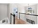 Bright hallway with hardwood floors and a view into a bedroom through an open doorway at 327 Horseshoe Bnd, Woodstock, GA 30189