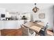 Bright, open kitchen and dining area featuring white cabinetry, granite countertops, and stainless steel appliances at 327 Horseshoe Bend Bnd, Woodstock, GA 30189