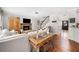 Open-concept living room with fireplace, hardwood floors, and staircase leading to the second floor at 327 Horseshoe Bend Bnd, Woodstock, GA 30189