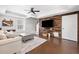 This modern living room features wood accent wall, recessed lighting, and a decorative ceiling fan at 327 Horseshoe Bnd, Woodstock, GA 30189