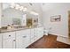 Bathroom featuring a granite countertop, white cabinets, and an oversized mirror at 327 Horseshoe Bend Bnd, Woodstock, GA 30189