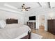 Bright main bedroom featuring tray ceilings, a ceiling fan, hardwood floors and white walls at 327 Horseshoe Bnd, Woodstock, GA 30189