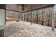 This home boasts a covered back patio with stone flooring overlooking a wooded backyard with a fire pit at 327 Horseshoe Bend Bnd, Woodstock, GA 30189