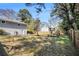 Backyard featuring a large grassy area, wooden fence, play set, and the back of the house at 959 Frontier Sw Trl, Marietta, GA 30060