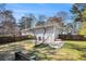 View of a spacious backyard with a grassy lawn, wooden fence and the back of the home at 959 Frontier Sw Trl, Marietta, GA 30060