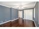 Bedroom featuring hardwood floors, white trim, ceiling fan and closet doors at 959 Frontier Sw Trl, Marietta, GA 30060