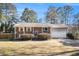 Charming brick home featuring a well-manicured lawn and attached one-car garage at 959 Frontier Sw Trl, Marietta, GA 30060