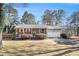 Classic brick home featuring a well-manicured lawn and an attached garage at 959 Frontier Sw Trl, Marietta, GA 30060