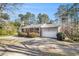 Cozy brick home featuring a well-manicured lawn and convenient driveway to the attached garage at 959 Frontier Sw Trl, Marietta, GA 30060