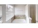 Bright bathroom featuring natural light, neutral walls and a tub and shower combo at 2357 Wellborn Hills Pl, Lithonia, GA 30058