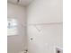 Laundry area features white walls, wire shelf and a window at 2357 Wellborn Hills Pl, Lithonia, GA 30058
