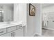 Main bathroom with modern vanity, towel and view of walk-in closet at 5834 Schelton Se Pl, Mableton, GA 30126