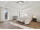 Serene main bedroom with tray ceilings, large windows, and neutral decor at 6315 Buckingham Cir, Cumming, GA 30040