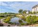 Scenic community shot featuring a serene pond, lush landscaping, and nearby apartments at 416 Glen Iris Ne Dr, Atlanta, GA 30308