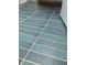 Aqua colored bathroom floor with thin bright tile lines gives a clean and modern feel at 496 Federal Se Ter, Atlanta, GA 30315