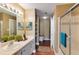 Bright bathroom with vanity, shower, walk in closet, and an open view of the toilet at 1101 Juniper St # 61, Atlanta, GA 30309