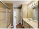 Bright bathroom features a shower-tub combo with a glass door and a vanity with a large mirror at 1101 Juniper St # 61, Atlanta, GA 30309