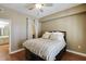 This bedroom features a fan, wood floors, and a closet in the same space as the adjacent bathroom at 1101 Juniper St # 61, Atlanta, GA 30309