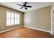 Bright bedroom featuring wood floors, plantation shutters, and ceiling fan at 1101 Juniper St # 61, Atlanta, GA 30309