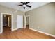 Inviting bedroom with multiple access doors, hardwood floors, and ceiling fan at 1101 Juniper St # 61, Atlanta, GA 30309