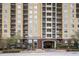 High-rise building exterior showing a building entrance with covered parking access and well-maintained landscaping at 1101 Juniper St # 61, Atlanta, GA 30309