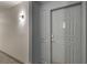 Apartment 61 is behind this gray door with stylish trim and modern lighting at 1101 Juniper St # 61, Atlanta, GA 30309