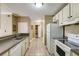 Traditional kitchen with tile floor, stainless sink, and white appliances and cabinets at 1101 Juniper St # 61, Atlanta, GA 30309
