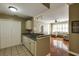 Inviting kitchen featuring white cabinets, tile floor and seamless transition to living area at 1101 Juniper St # 61, Atlanta, GA 30309