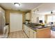 Cozy kitchen with white cabinets, tile floor and seamless transition to living area at 1101 Juniper St # 61, Atlanta, GA 30309