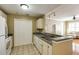 A well-lit kitchen featuring white cabinets, tile flooring, and a functional layout at 1101 Juniper St # 61, Atlanta, GA 30309